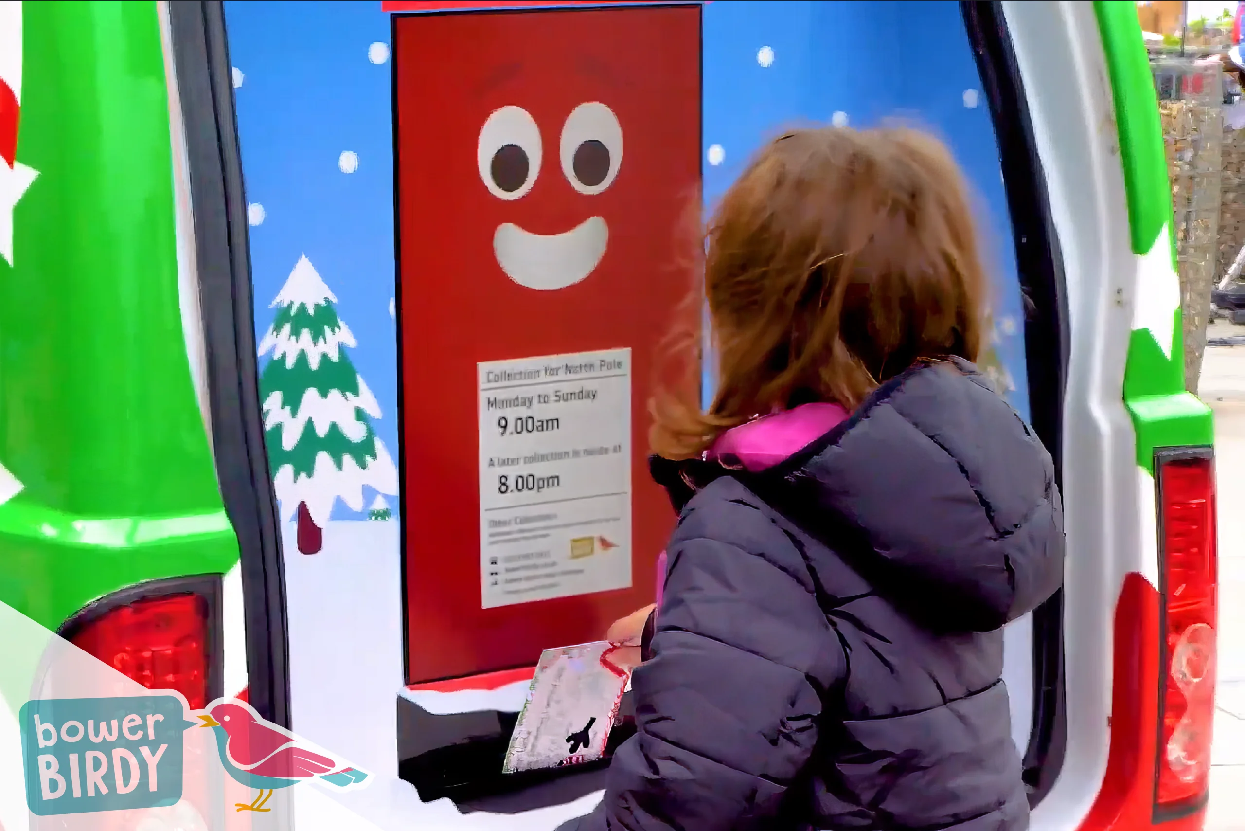 A young girl posting a letter into the Enchanted Postbox in Bowerbirdy's Magical Elf Car - Christmas in Streatham