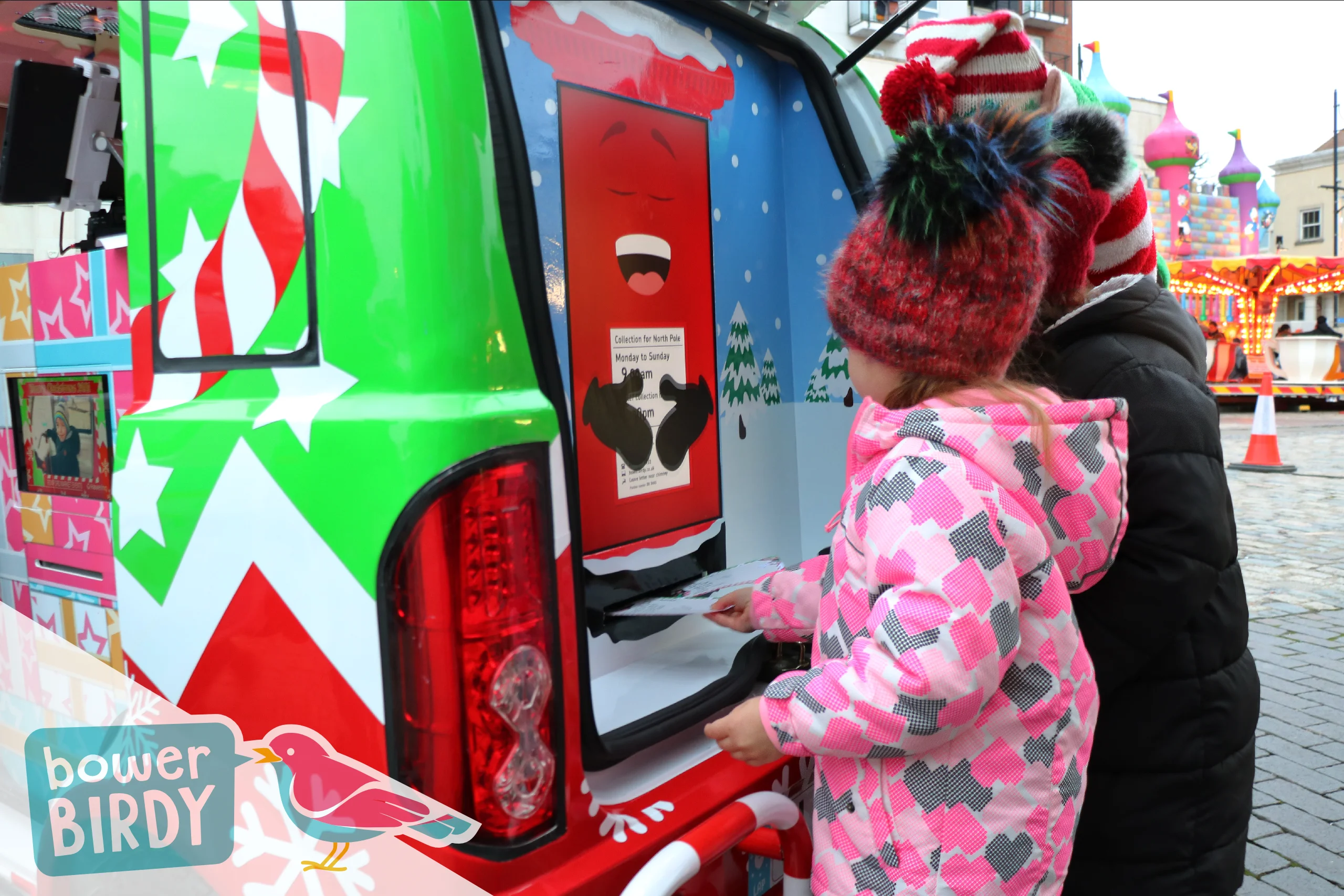 Elf Car Christmas Event: Two young children post their christmas lists into the Enchanted Postbox.