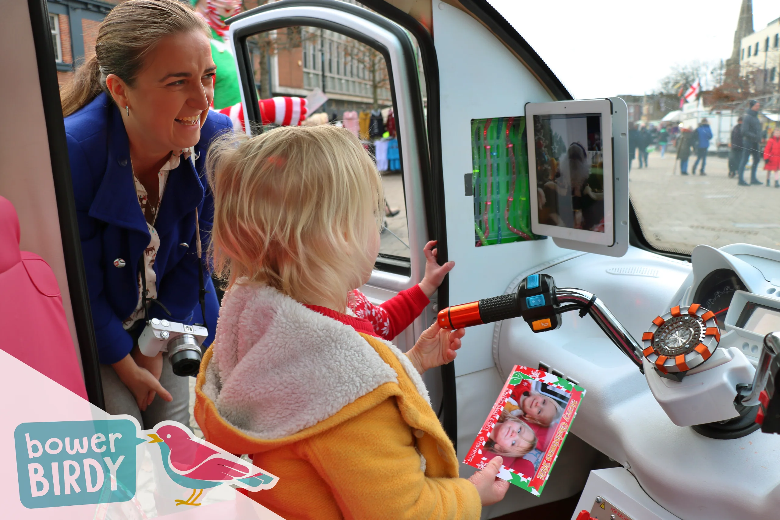 Elf Car Christmas Event: Two young children and their mum have a video call with Santa inside the Elf Car