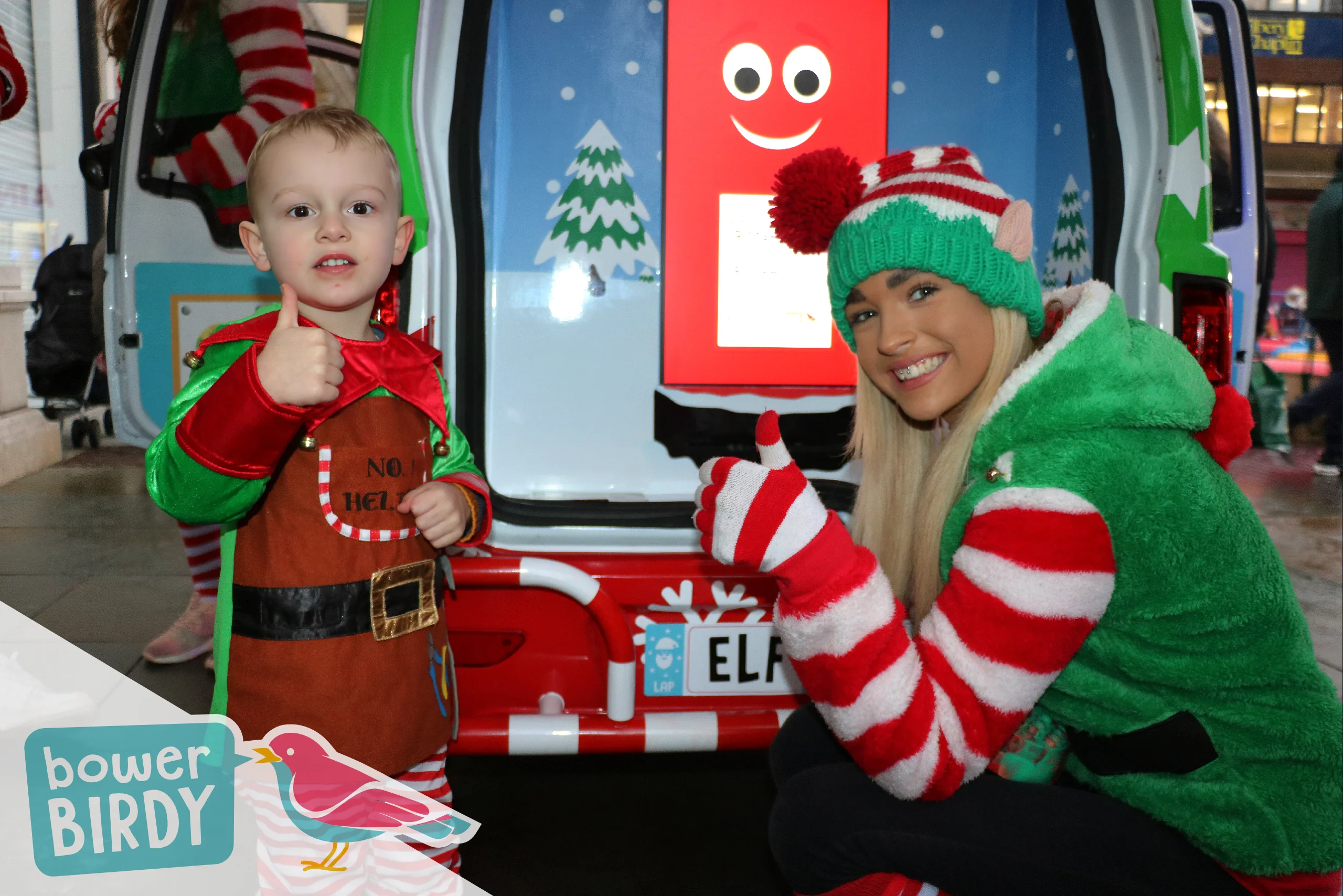 Elf Car Christmas Event: A young boy dressed in an elf costume give a thumb up with a Bowerbirdy elf.