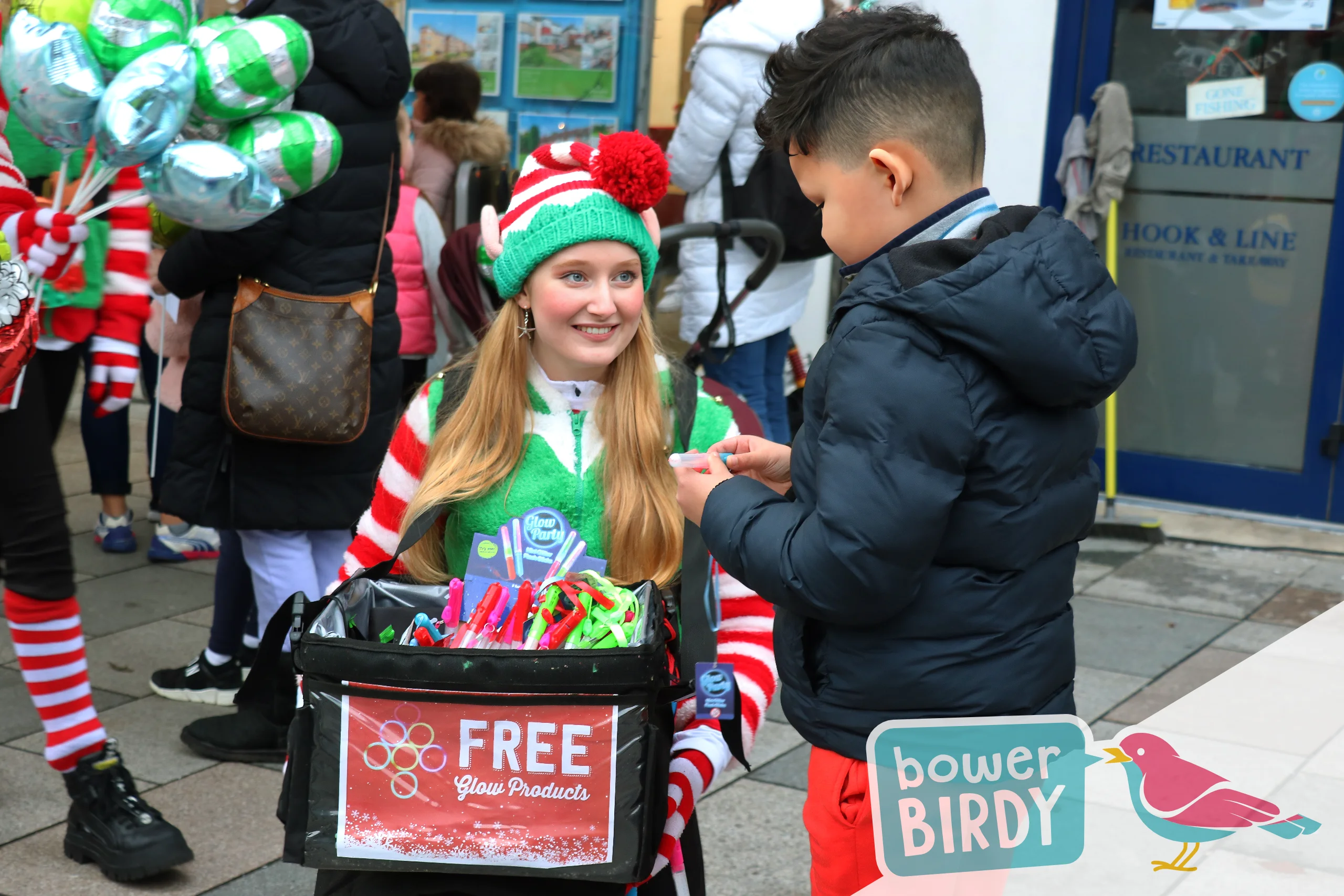 Christmas Fun with the Magical Elf Car: A boy receives a free glow stick from a Bowerbirdy elf