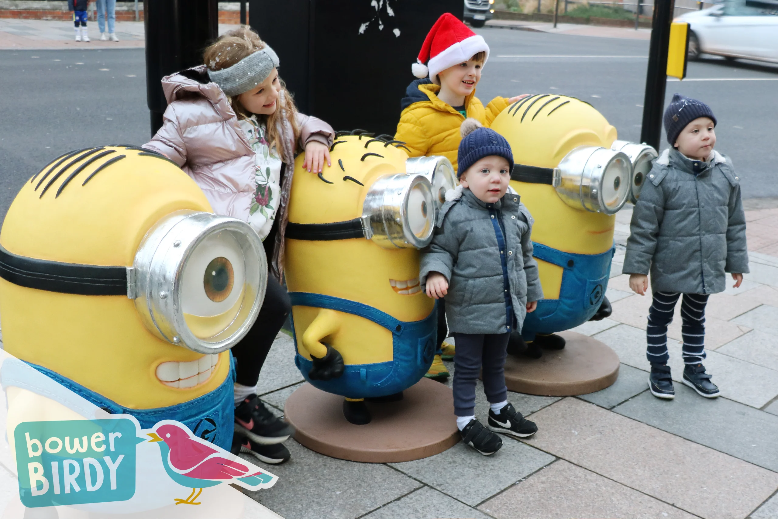 Christmas Fun with the Magical Elf Car: Four children pose with life-sized models of The Minions