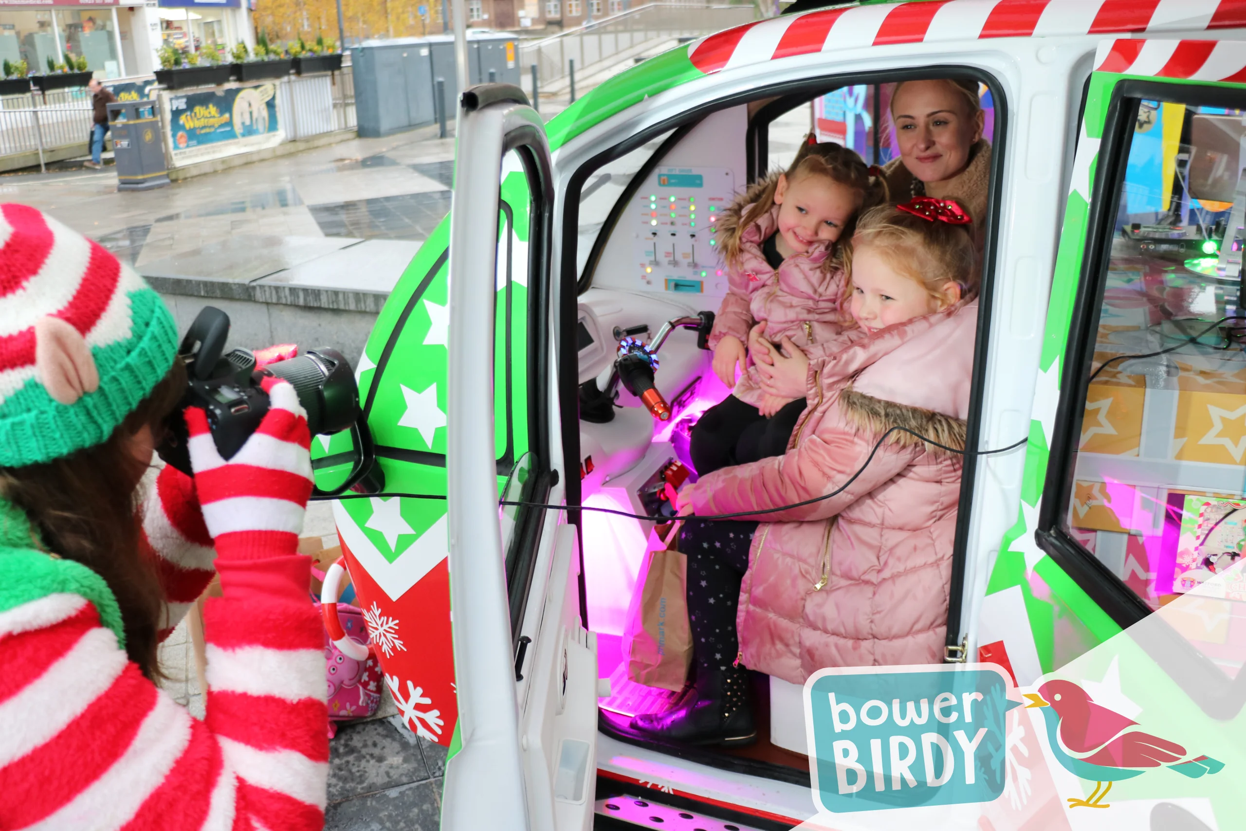Christmas Magic in Watford: A mum and her two young daughters have their photo taken in the Elf Car