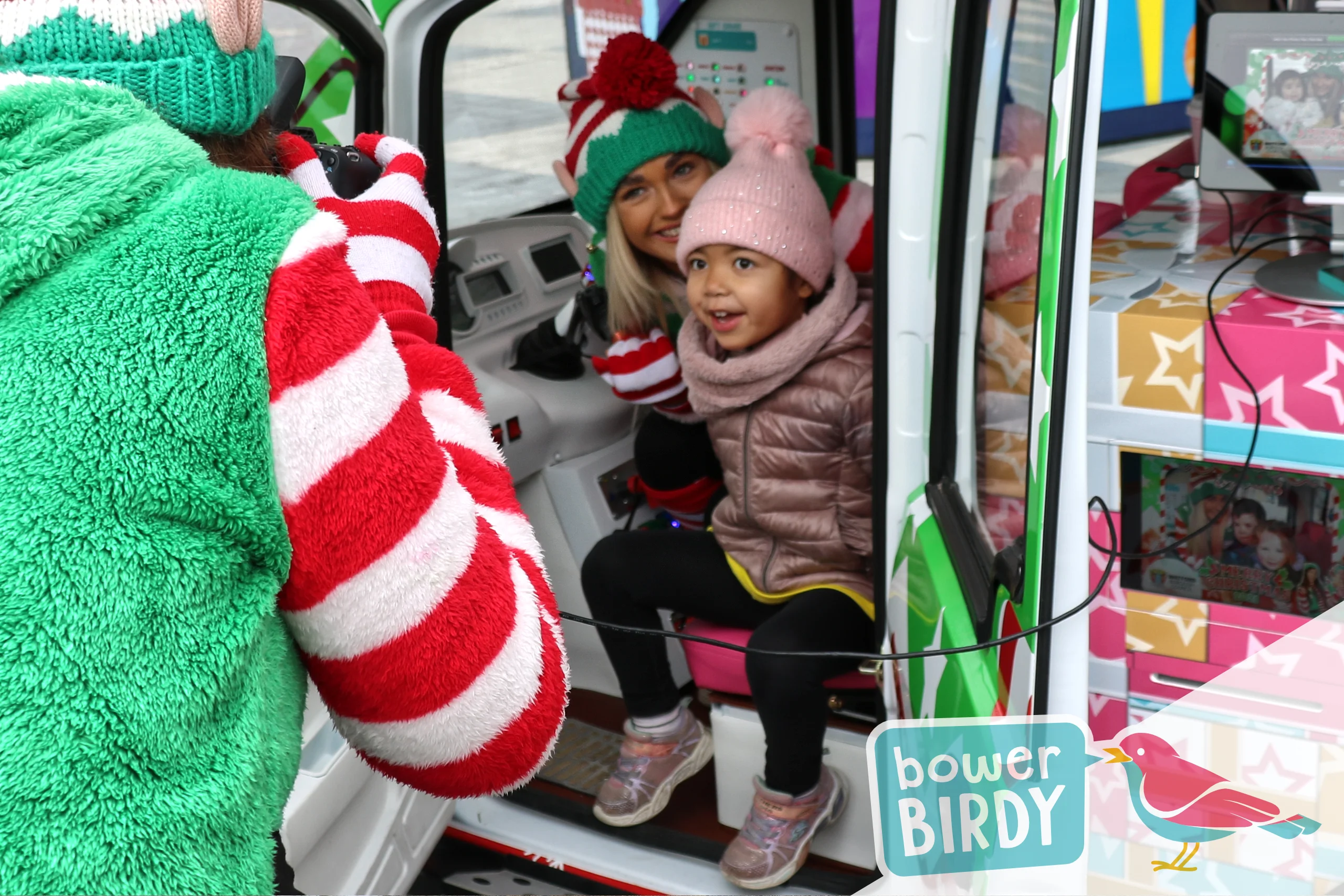 A young girl gets her photo taken inside the Elf Car