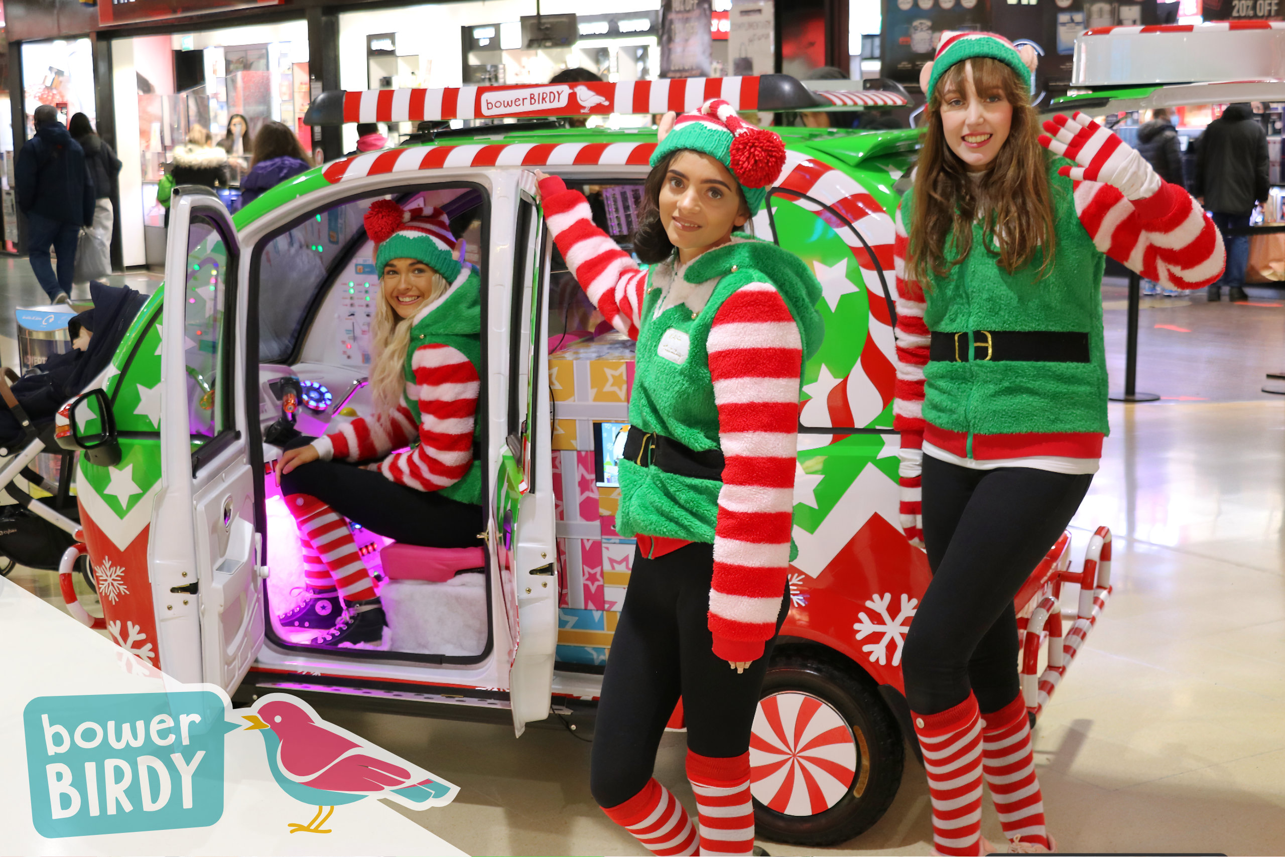 Christmas Shopping Centre Events: The Elf Car and three elves.