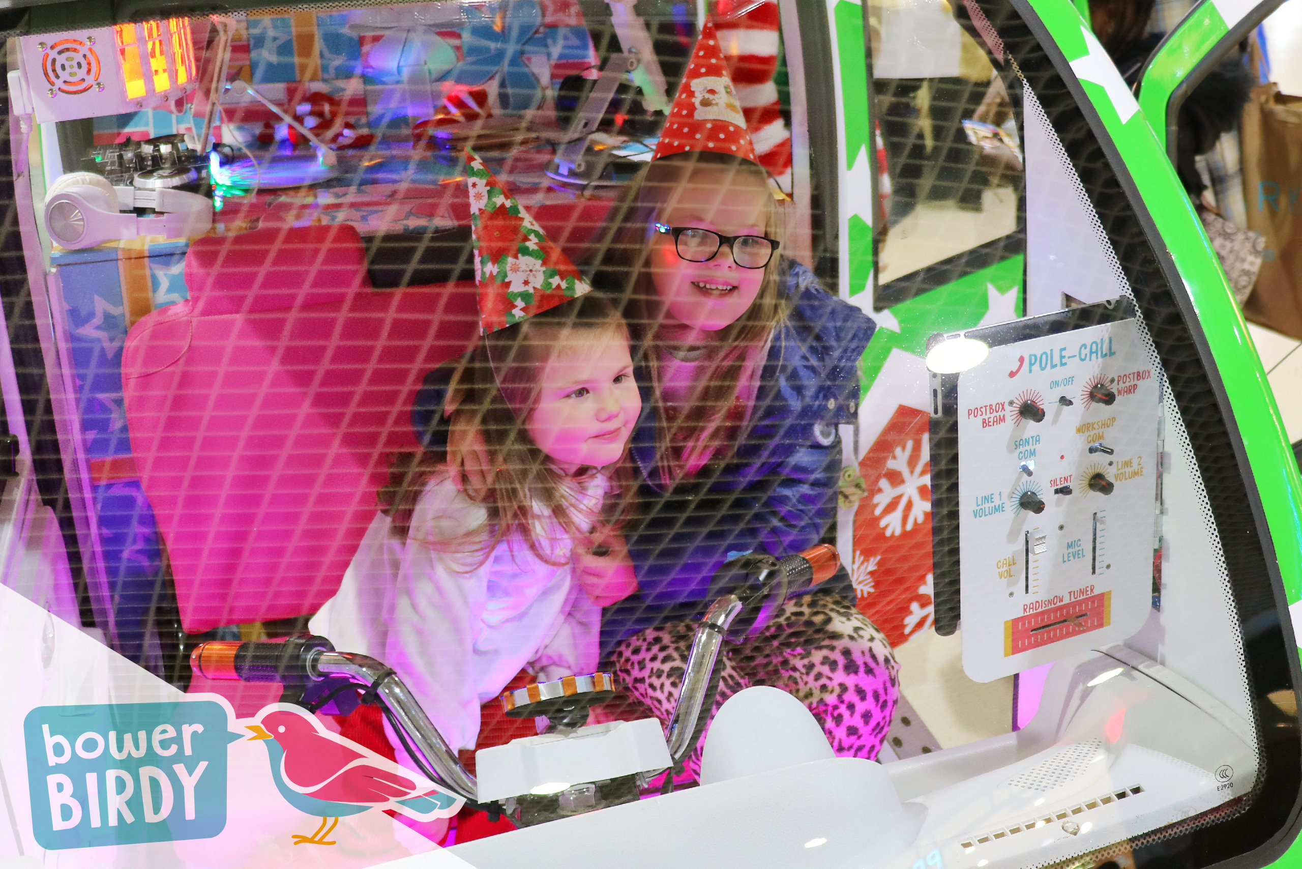 Christmas Shopping Centre Events: Two girls video call Santa from inside the Elf Car.