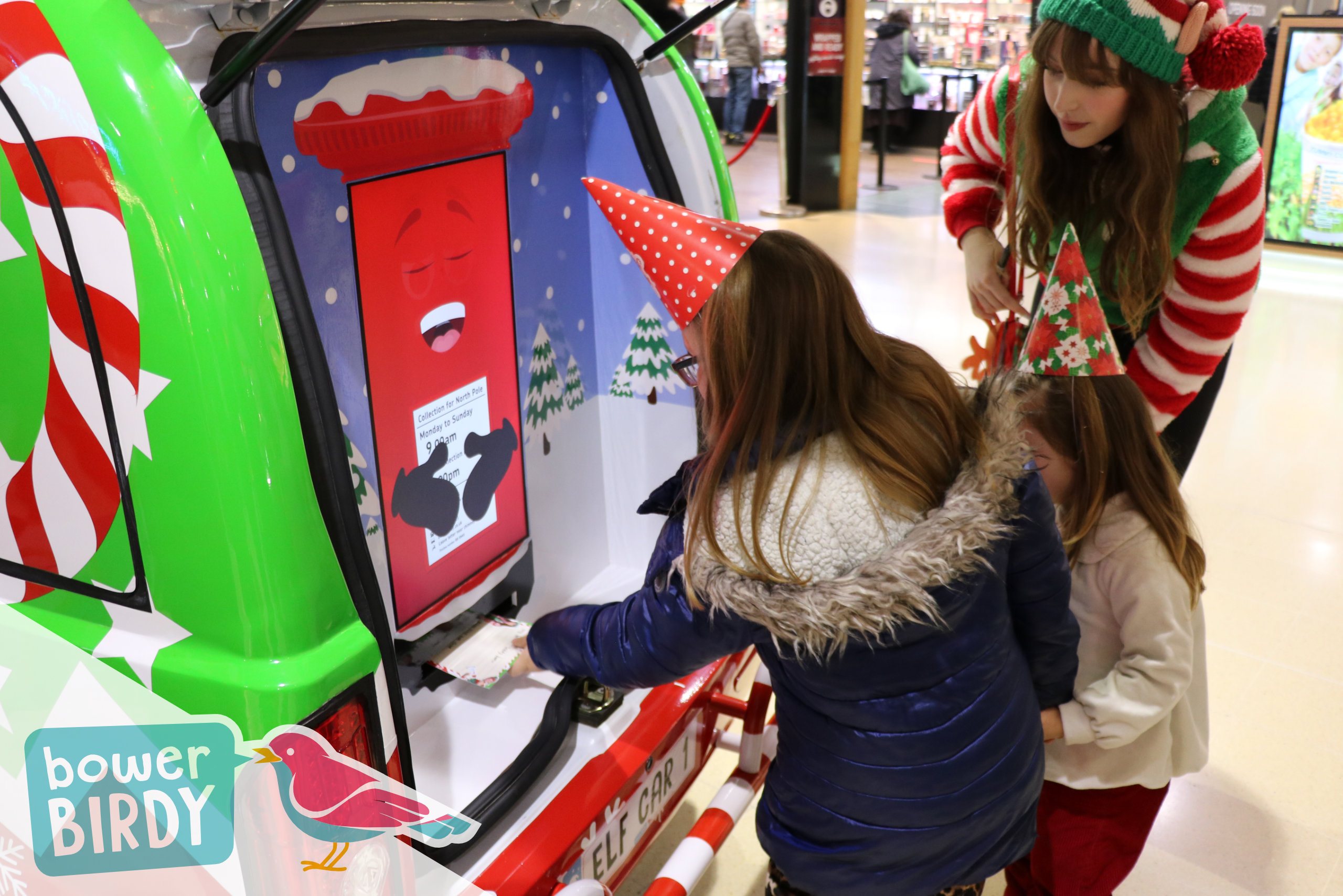 Two girls post their Christmas lists into the Enchanted Postbox